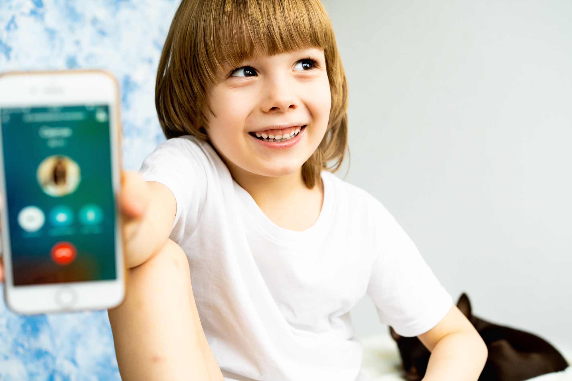 A little boy with a mobile phone, telephone communication in messengers, modern children, gadgets