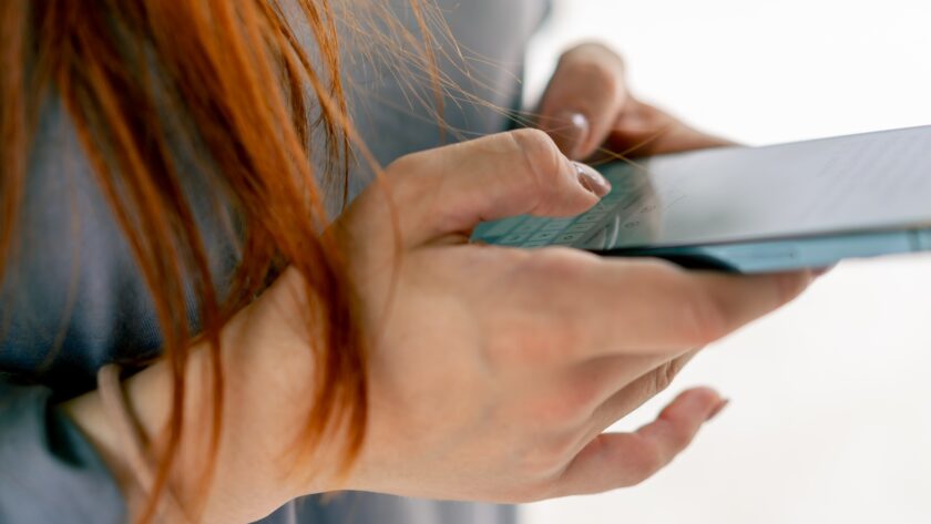 close-up of female hands holding smartphone texting with a girlfriend or a friend in messenger