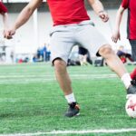 Football Coach Leading Ball