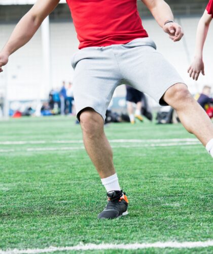 Football Coach Leading Ball