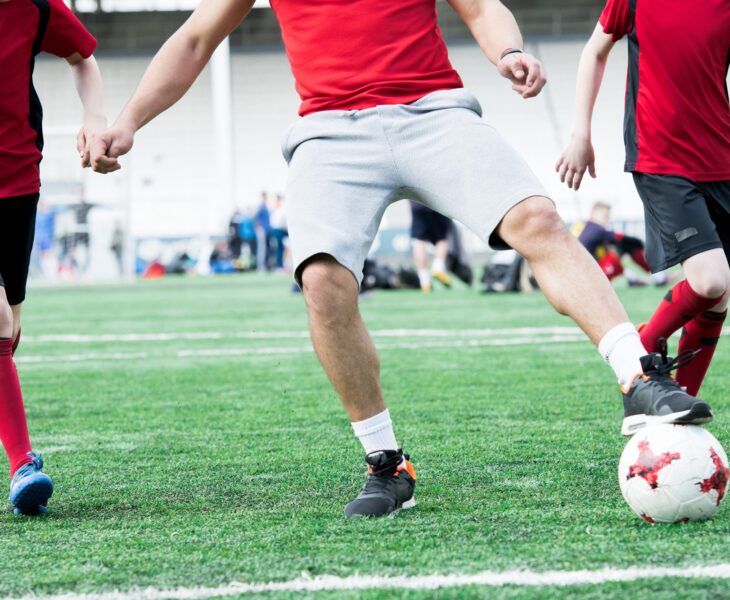 Football Coach Leading Ball
