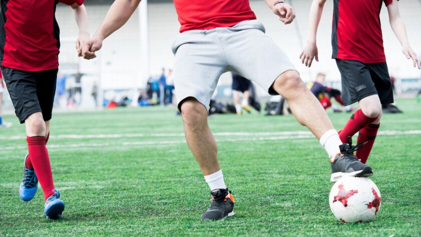 Football Coach Leading Ball