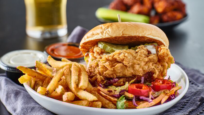 fried chicken sandwich with coleslaw and french fries