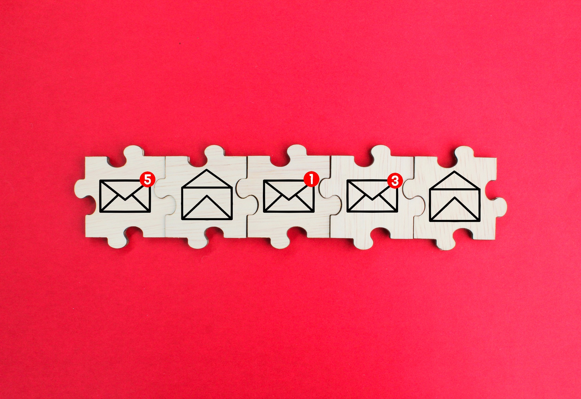wooden puzzle with read and unread email icons.