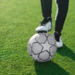 Close-up of soccer ball and feet of a football player