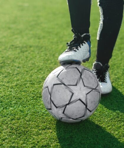 Close-up of soccer ball and feet of a football player