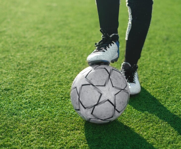Close-up of soccer ball and feet of a football player