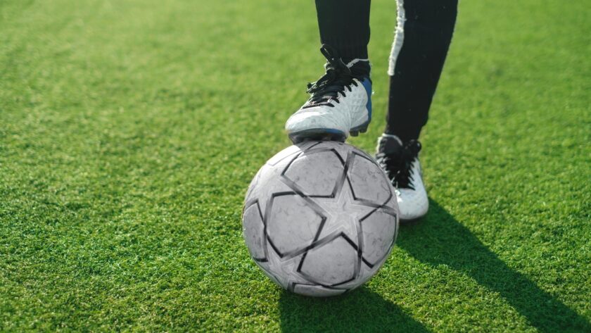 Close-up of soccer ball and feet of a football player