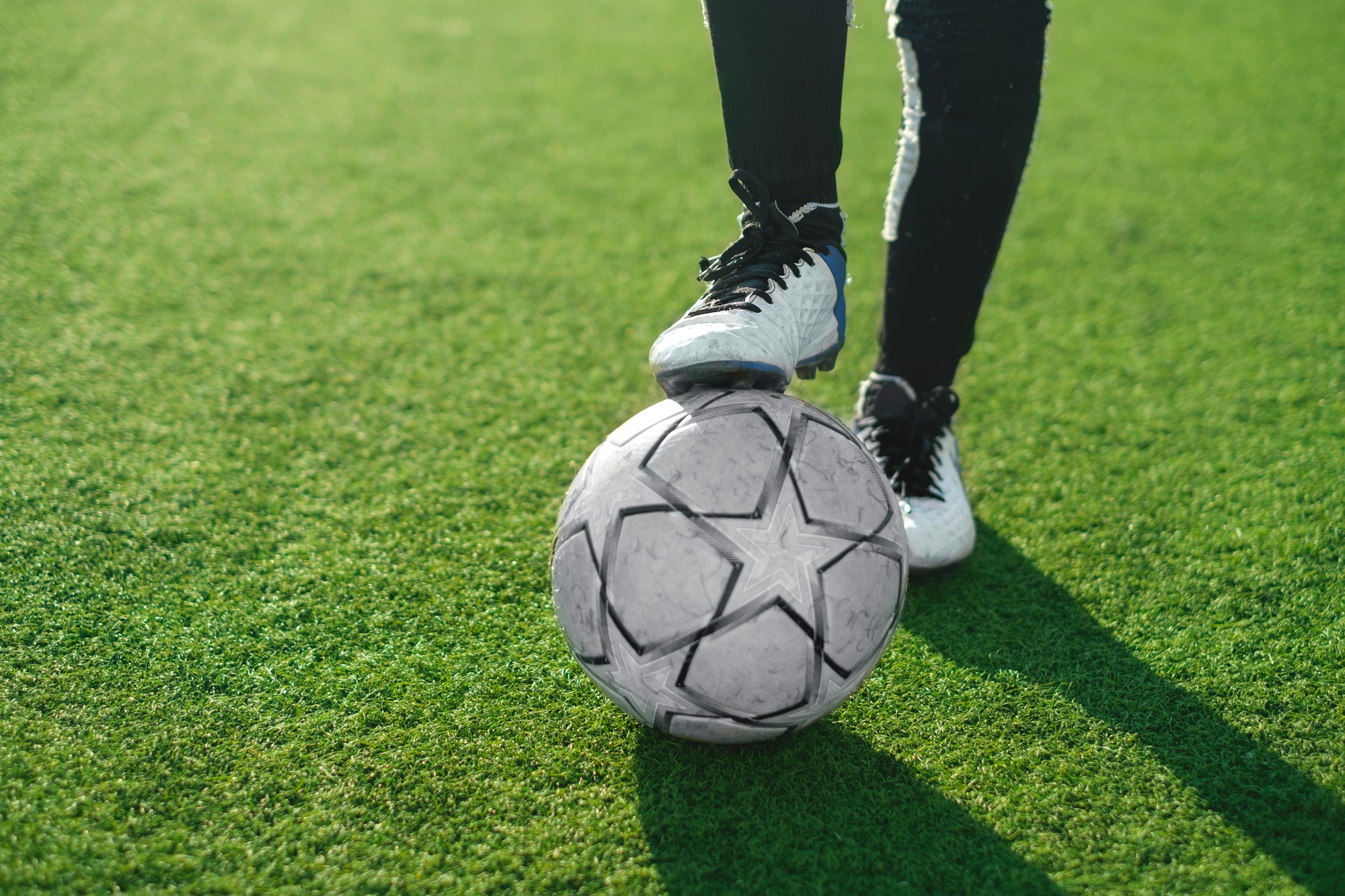 Close-up of soccer ball and feet of a football player