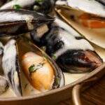 Creamy mussels on wooden background