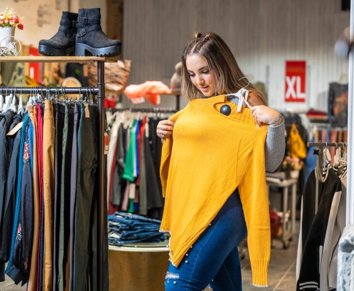 Overweight woman trying on clothes in a clothing store in the plus size section