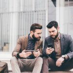 Two casual businessmen using tablet