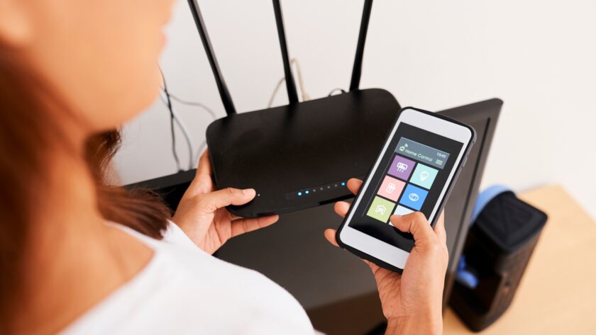 Woman Connecting to Wi-fi Router