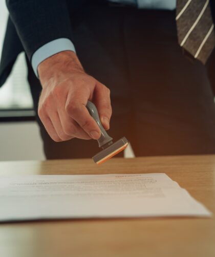 Hand stamping with approved stamp on certificate document